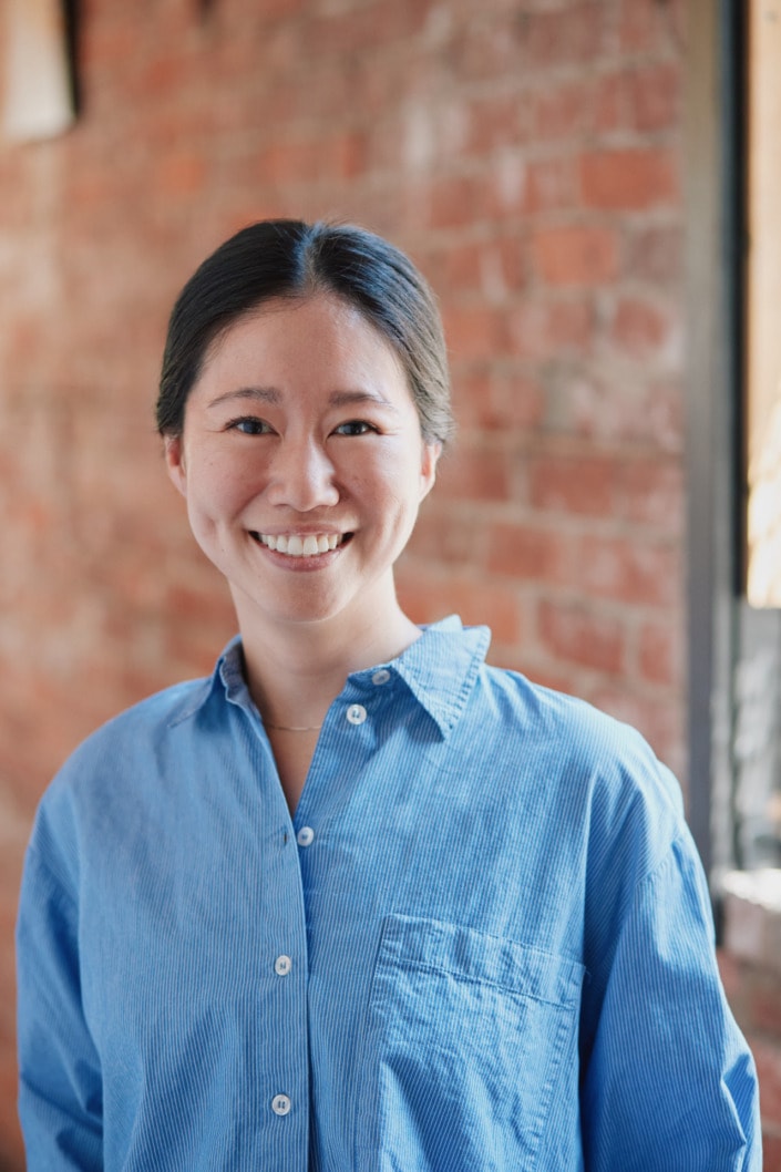 environmental professional female headshot vancouver with red brick background