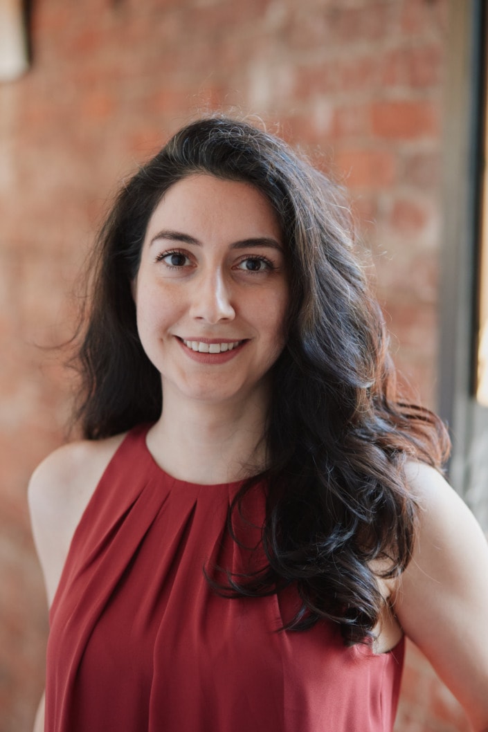 natural light female headshot with red brick background